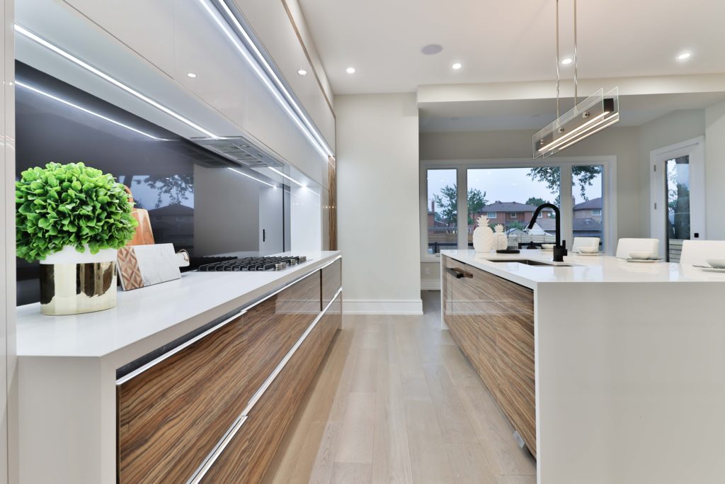 View of kitchen with timber drawers, white counter tops