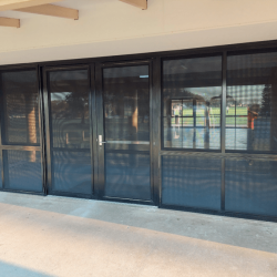 After - New aluminium pivot doors with sliding window side lights