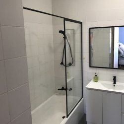 After - New black framed shower panel & mirror